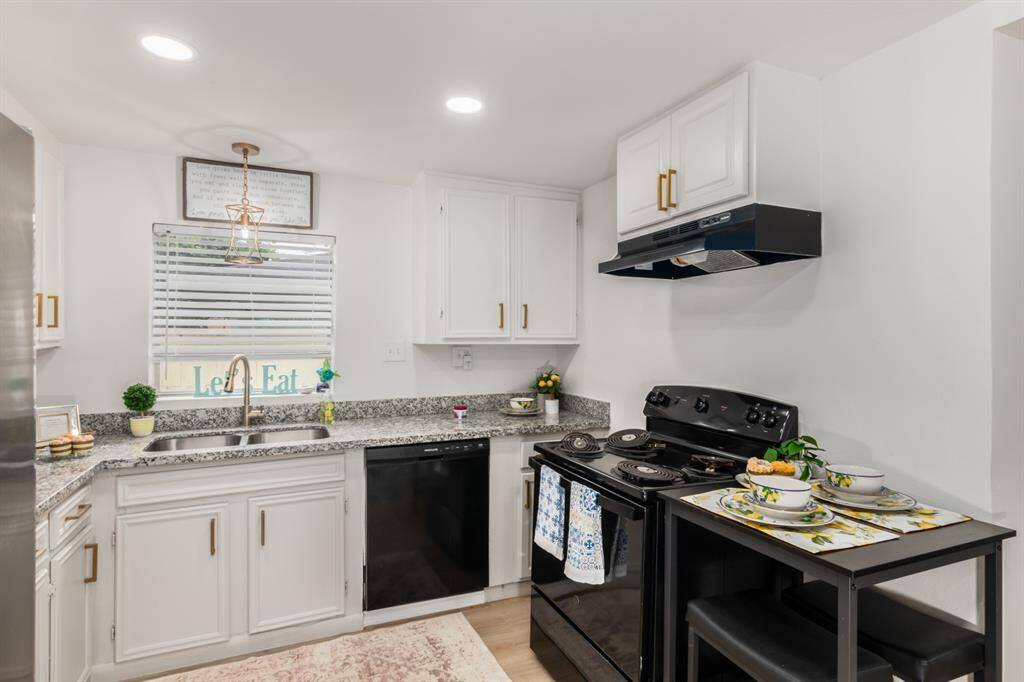 Updated bathroom with gold hardware modern grey cabinets.