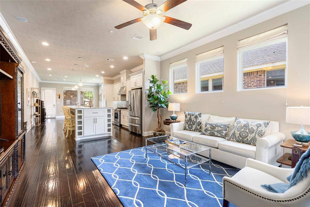 The warm and cozy living room is the perfect place to make memories with loved ones! High ceilings and beautiful flooring are hallmarks of this great space!