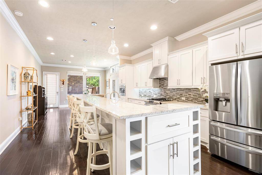 Prepare your gourmet meals in this spacious kitchen! Pendant lighting and stacked stone backsplash provide beauty and convenience.