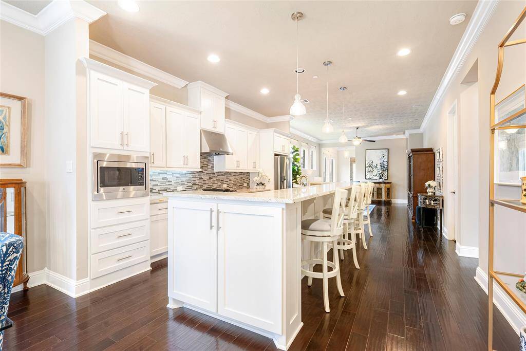 Breakfasts and snacks are convenient with a bar seating! There is no shortage of storage with an abundance of cabinetry and pantry!