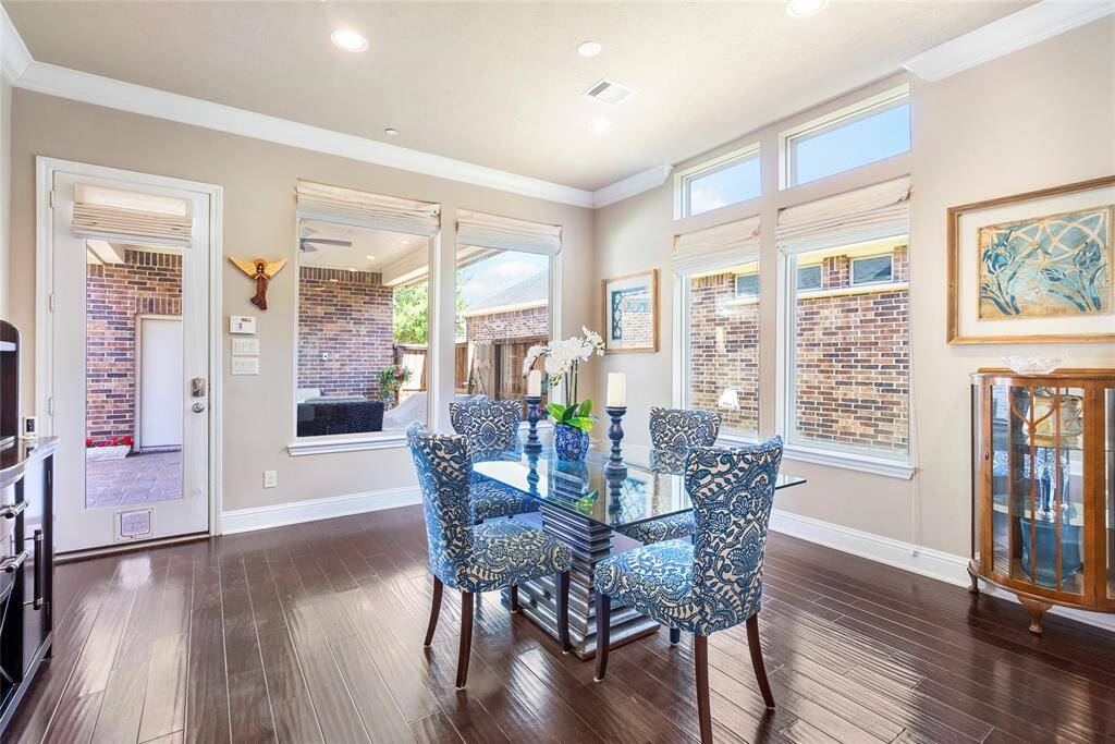 Enjoy picturesque views of the patio as you sip on your morning coffee! Large windows invite natural light to flow into this space.