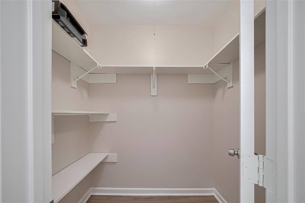 A full-sized pantry with multiple built-in shelves offers an organized solution for dry goods, kitchen tools, and more. Easily accessible, it’s a thoughtful extension of the kitchen’s functionality.