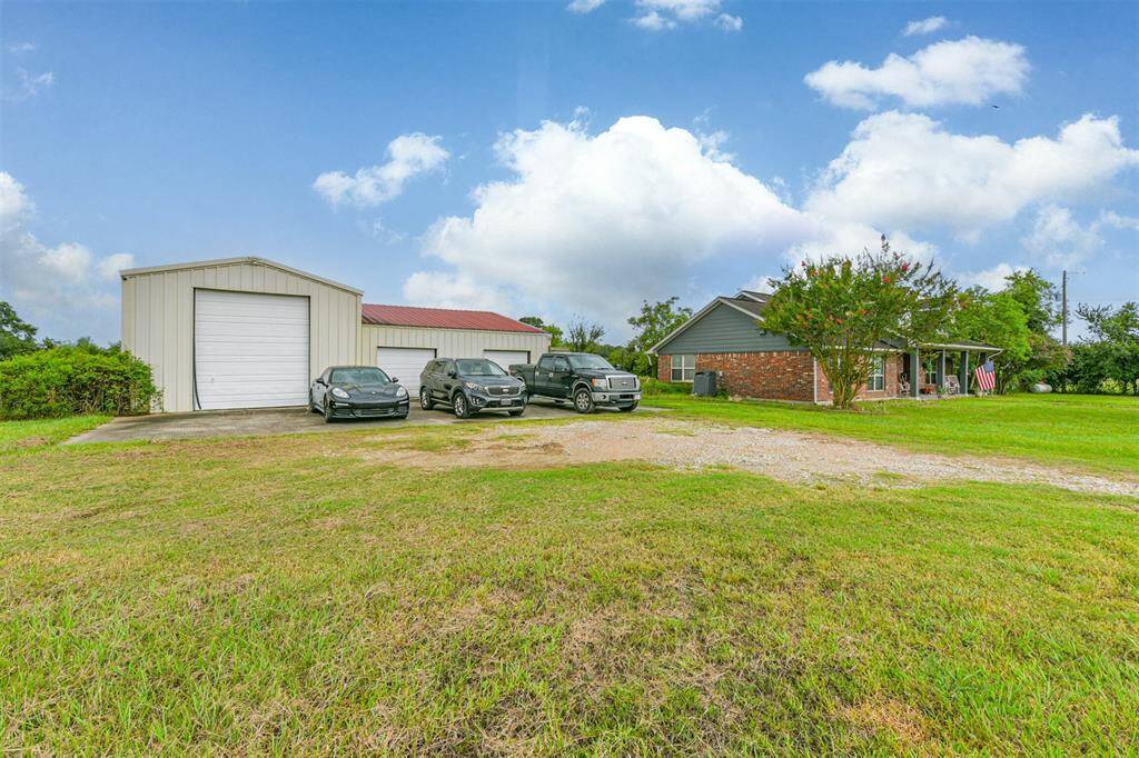 This is a single-story brick home with a de-attached shop/garage, set on a spacious lot with a well-maintained lawn.