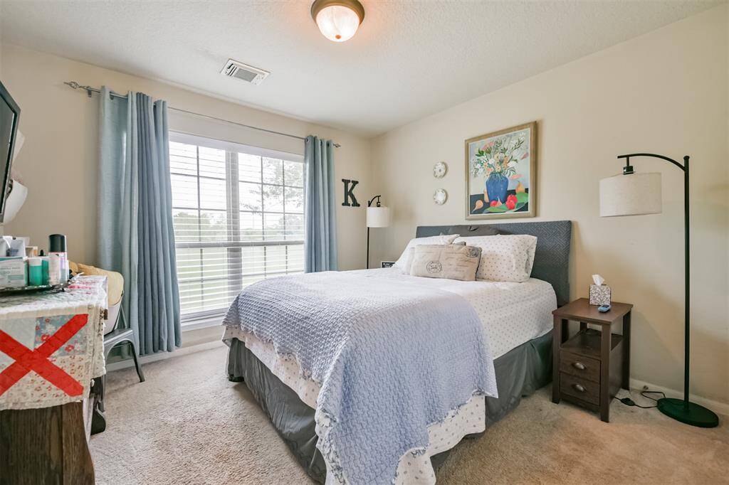 This is a well-lit cozy bedroom