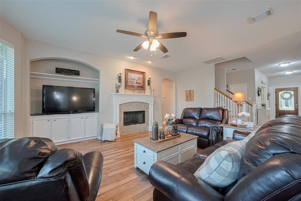 The heart of the home: a bright, neutral family room with built-in storage and a classic fireplace—ready for movie nights, quiet mornings, or anything in between.