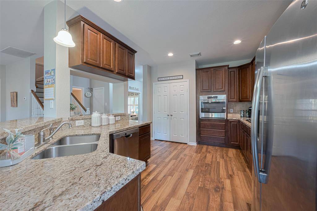 Designed for both style and function, the kitchen features ample workspace, smart storage solutions—including pots and pans drawers—recessed lighting, and a gas cooktop