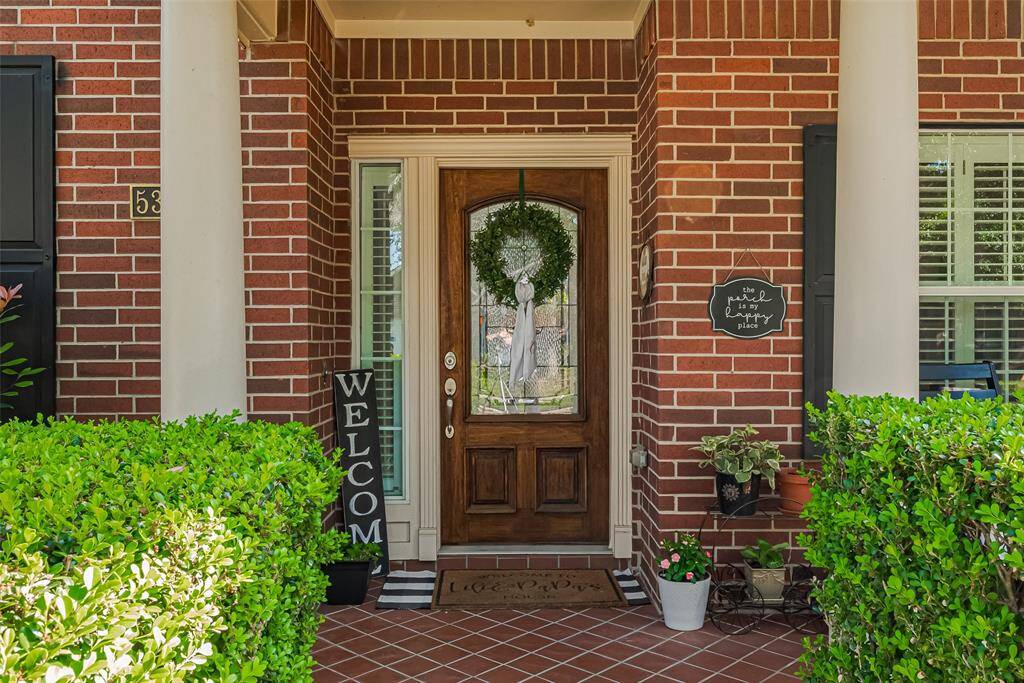 This classic two-story brick home has an inviting front porch & well-maintained, established landscaping & mature trees offering excellent curb appeal.