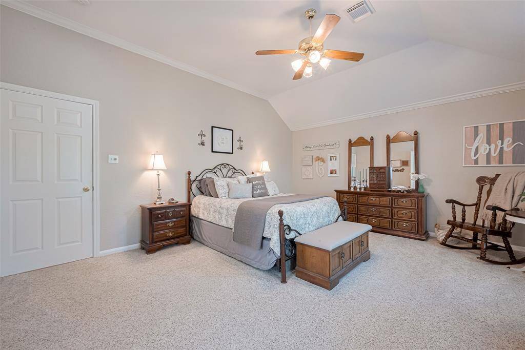 The primary retreat carries through the home’s calming, neutral tones for a seamless feel
