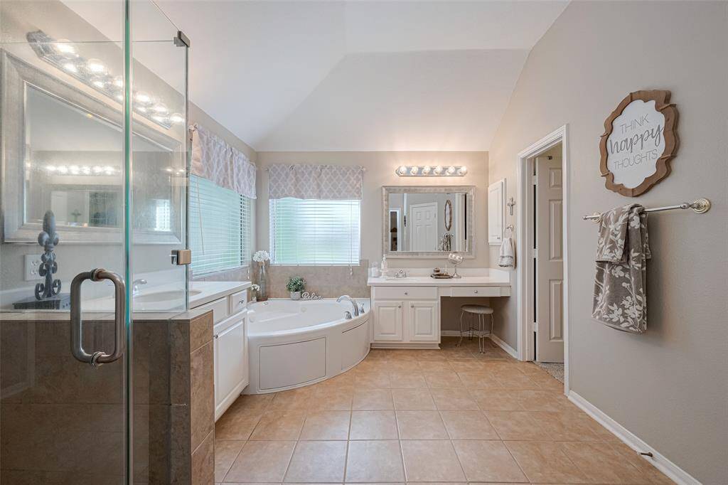 This expansive primary bath blends function and style with dual sinks, a frameless glass shower, and a deep jetted tub—perfect for a bit of everyday luxury