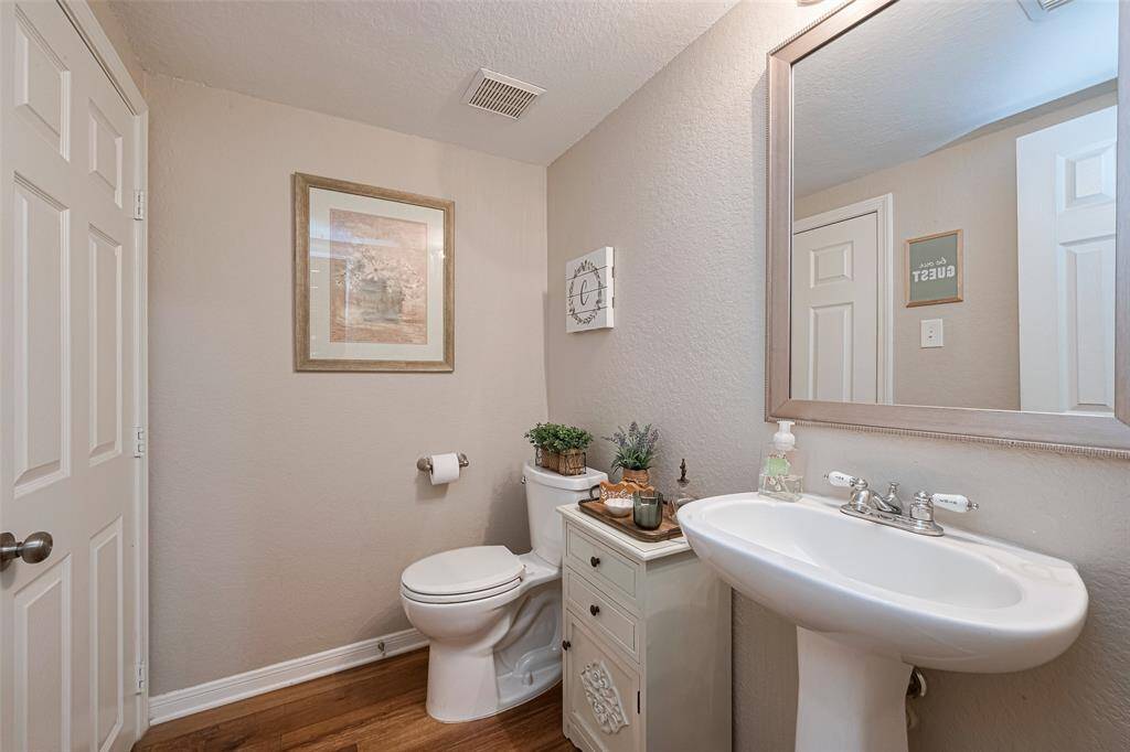 Conveniently located for guests, the main floor powder room also features an oversized storage closet—perfect for stashing extras out of sight