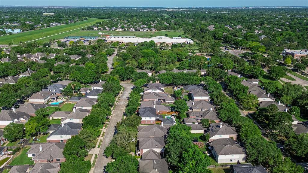 View of close proximity to the neighborhood park and swimming pool just one block away and Beck Jr. High in the background - easy access!