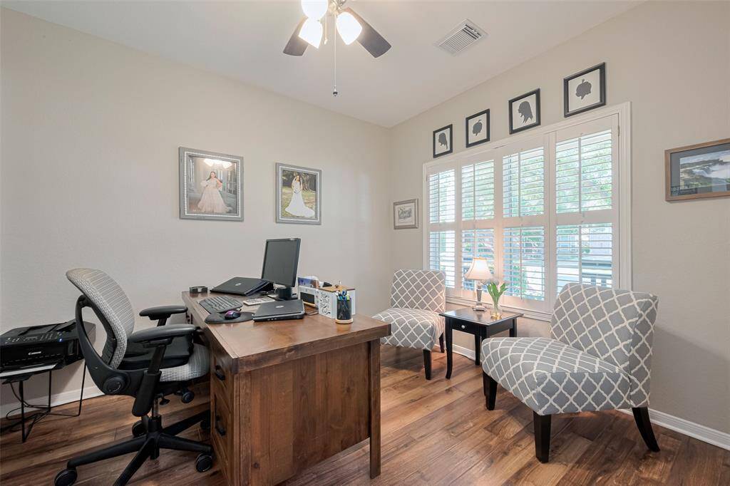...with stylish Plantation shutters overlooking the covered front porch.