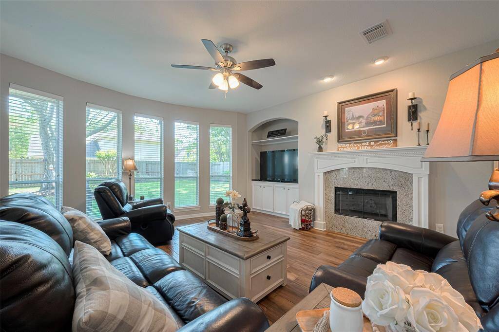 Built-in cabinets next to the gas fireplace add functional storage for the family room