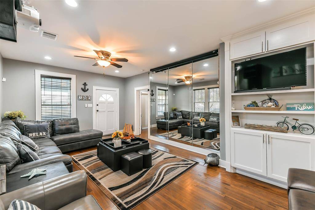 Recessed lighting enhances the space, complemented by extra cabinets and storage shelves.