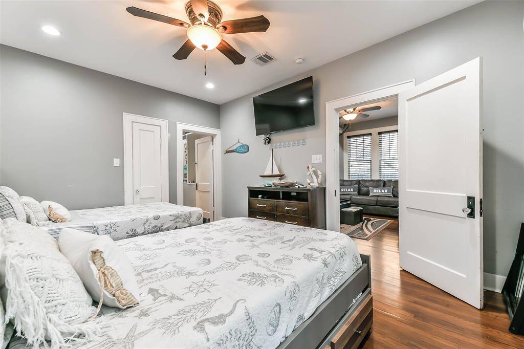 Bedroom #2 features a door leading to the front porch, another opening into the family room, and a third providing access to the hallway and hall bath.
