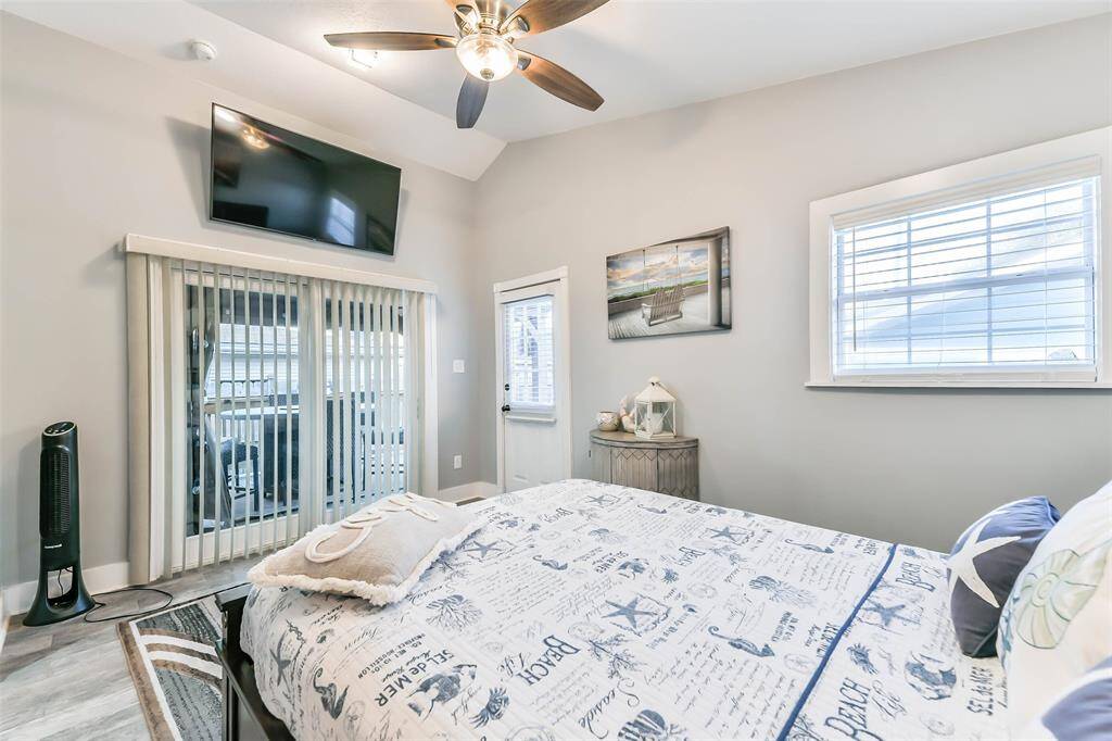 The primary bedroom features doors that open to both the back patio and the Gazebo on the patio.