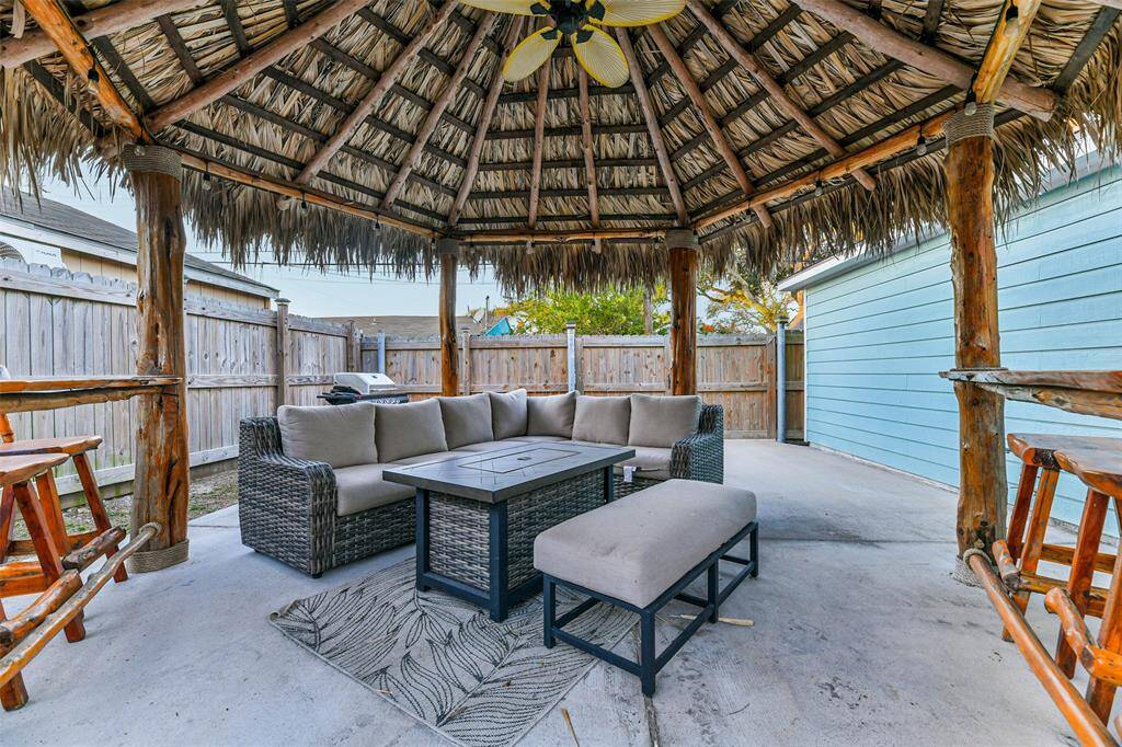 A covered palapa, enclosed by privacy fencing.