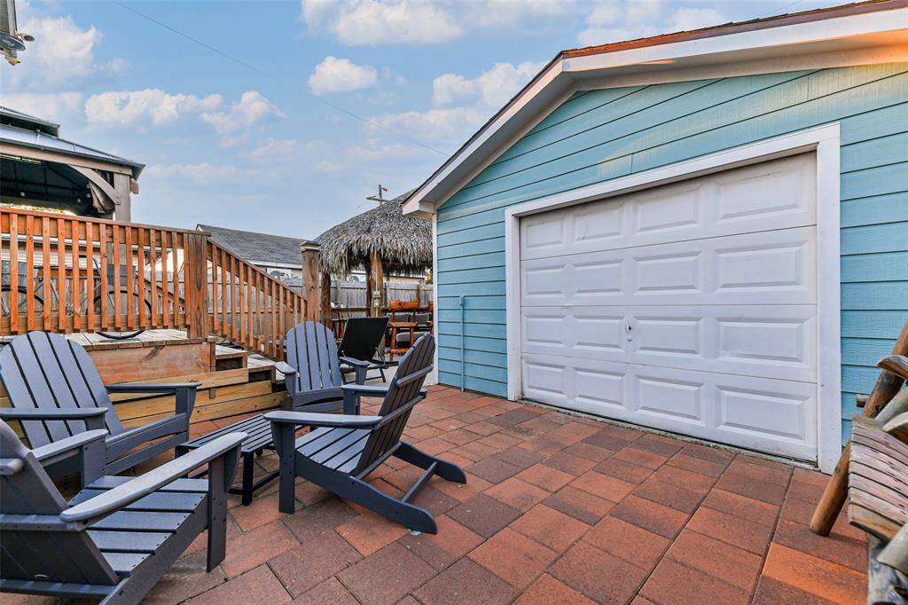 Patio decking and garage entrance.