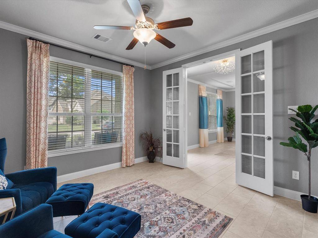 This dining area features modern tile flooring, a cozy dining set, and ample natural light from large windows and a glass door leading to the patio. A built-in cabinet offers small computer station .