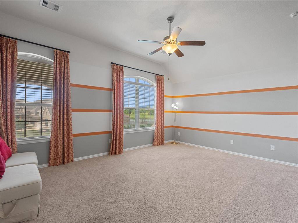 Second floor game room, features high ceilings, open concept and large windows. This room is large and perfect for entertainment.