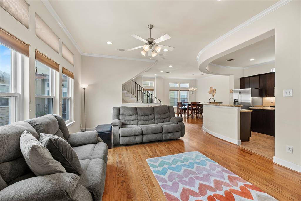 The expansive living area boasts striking ceiling lines and gorgeous wood floors, creating an ideal space for both lively family gatherings and elegant entertaining. And just wait until you see the rest of the house—it only gets better.