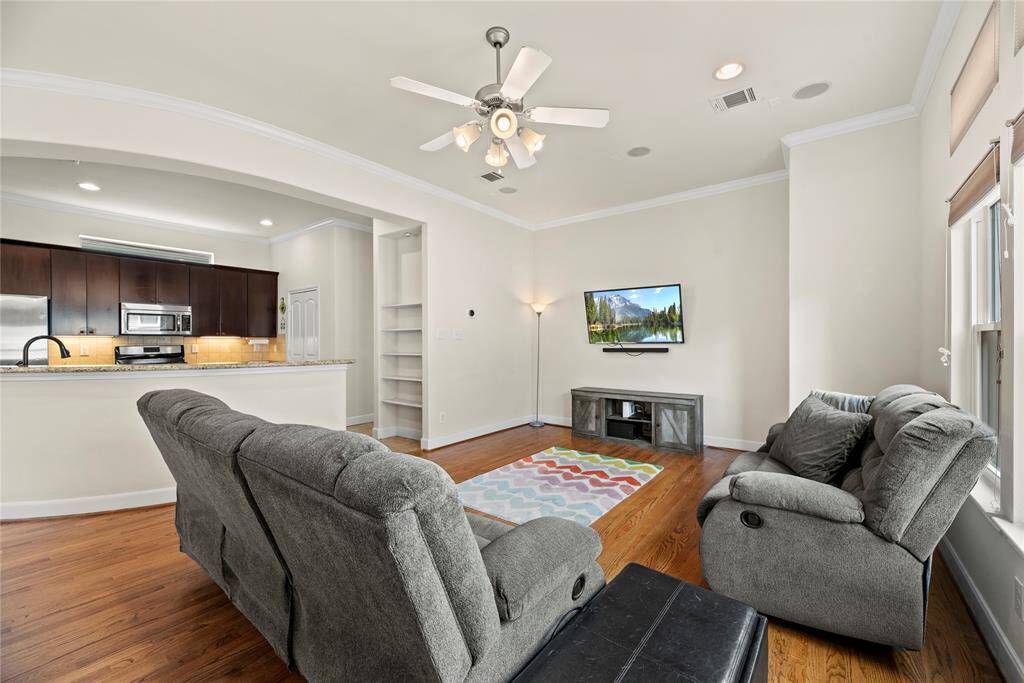 The living room, adjacent to the kitchen and breakfast area, offers a comfortable and inviting space for relaxation and socializing.