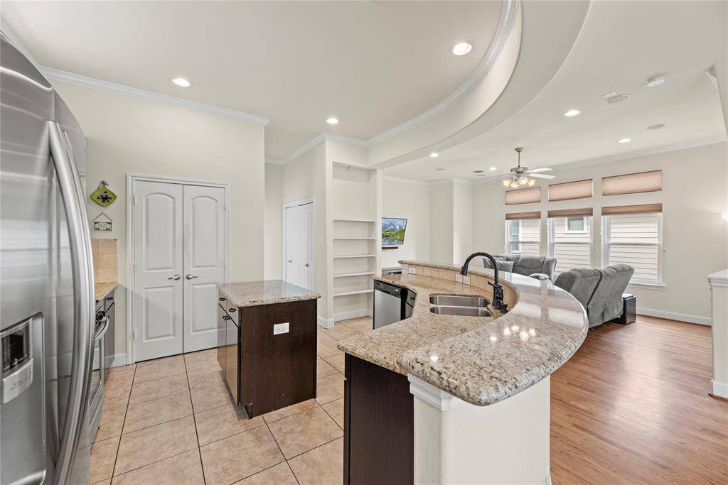 Granite countertops paired with a coordinating stone backsplash not only provide a durable and elegant surface for food preparation but also add a touch of luxury and sophistication to the kitchen.