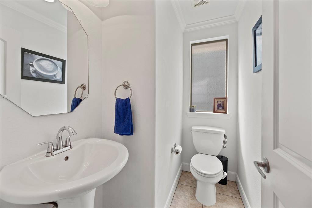 A stylish half bath adds convenience and elegance, perfect for guests and everyday use.