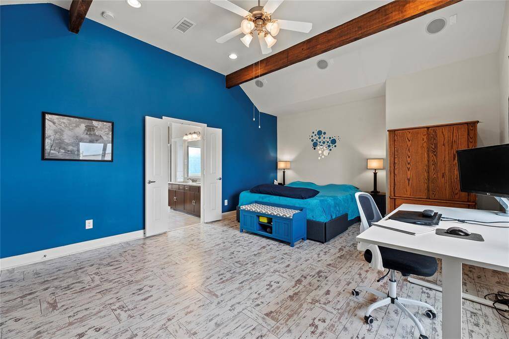 The exposed beams and vaulted ceiling creates a dramatic focal point that complements the overall aesthetic.
