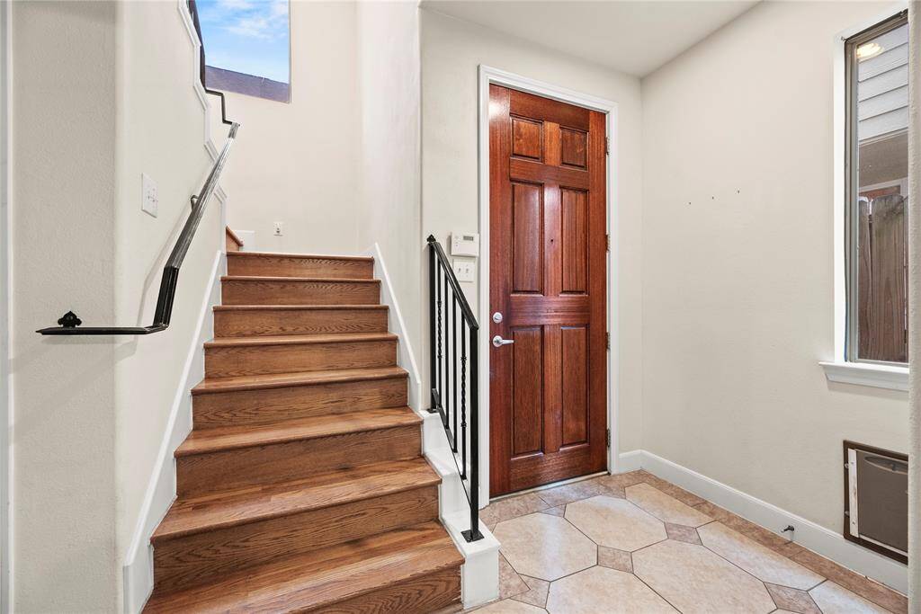 As you step inside, the front foyer greets you with exquisite tile flooring, setting the stage for the elegance and warmth that awaits throughout the home.
