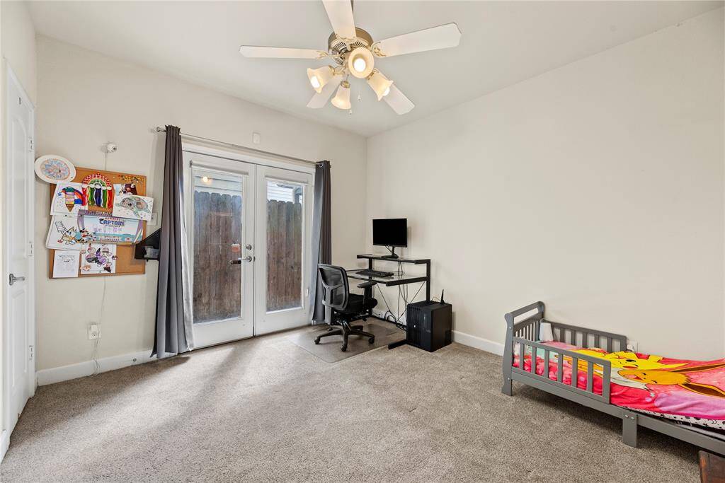 The downstairs bedroom is bathed in natural light, thanks to its expansive glass doors that create a bright and inviting atmosphere.