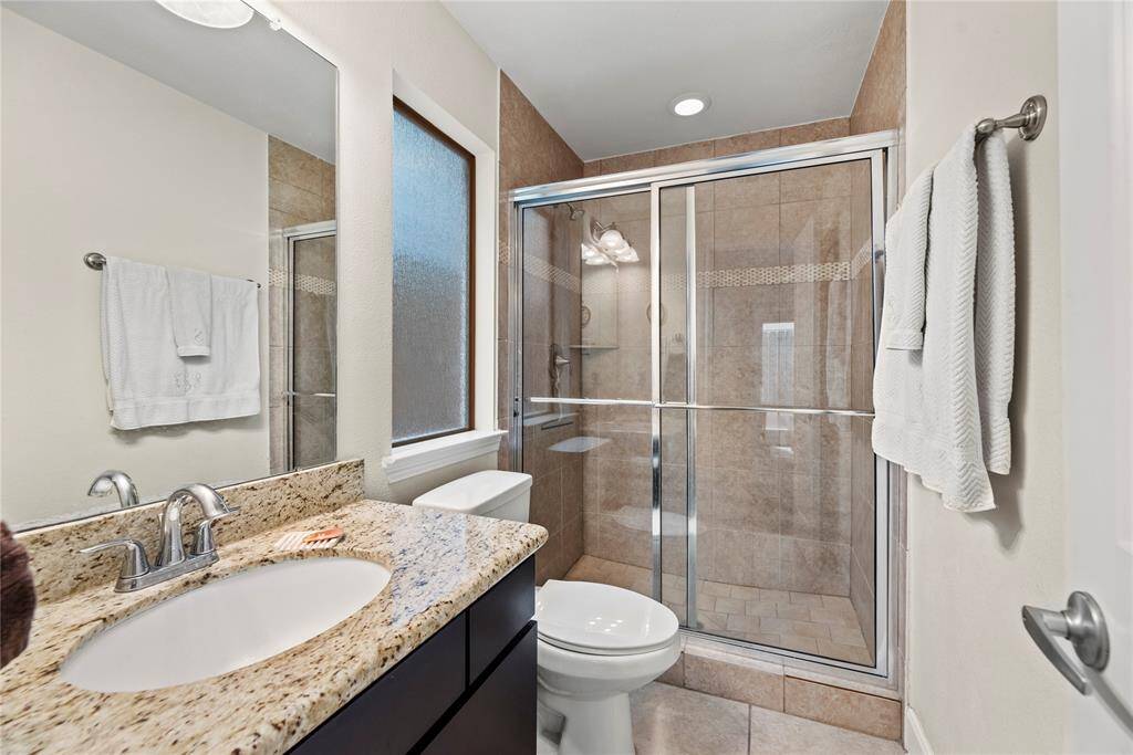 The en-suite bath offers a large vanity and walk in shower with stunning tile work and sleek glass front, ensuring privacy and comfort.