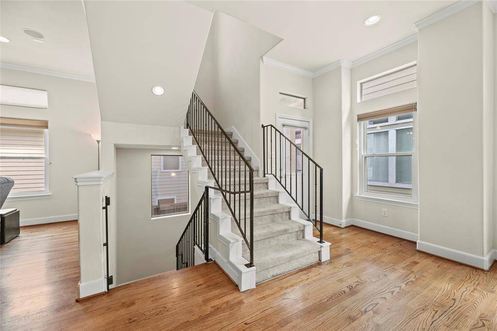 As you reach the second floor, you're welcomed by stunning wood floors that gleam under an abundance of natural light streaming in through the expansive windows.
