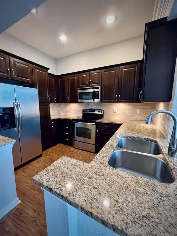 Large kitchen with lots of cabinets space & stainless steel appliances.