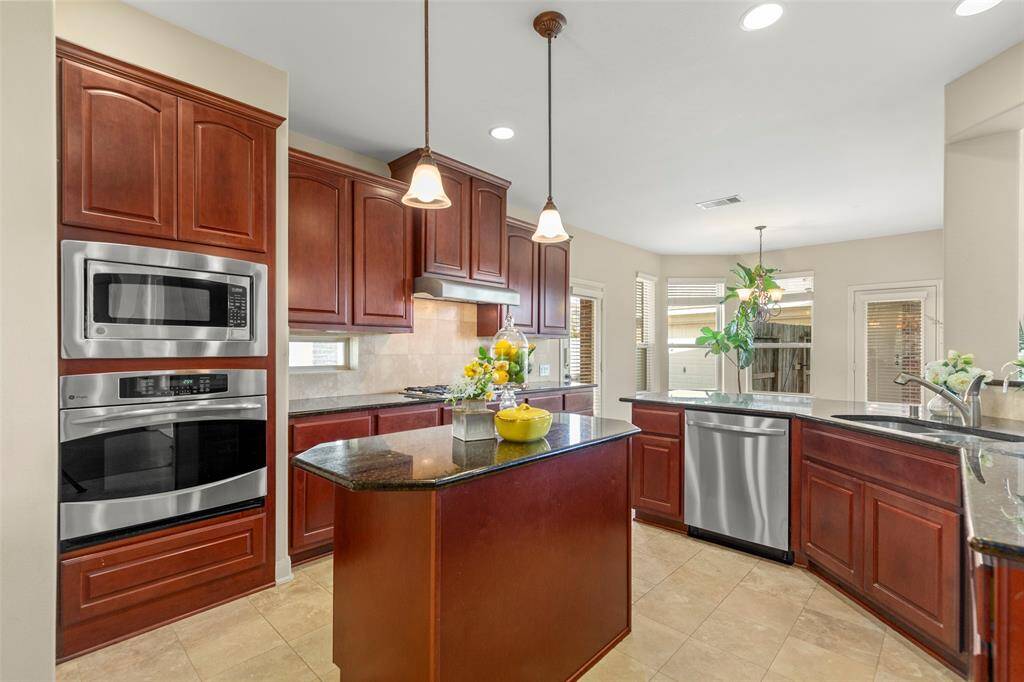 Kitchen with a cute island and lots of storage.