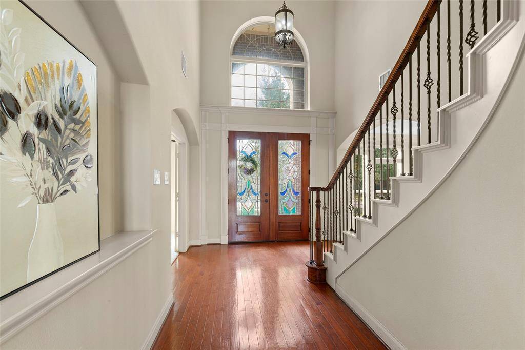 High celing entry foyer with wood floors.