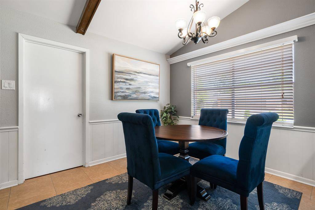 Vaulted ceiling and wood beams in breakfast room.