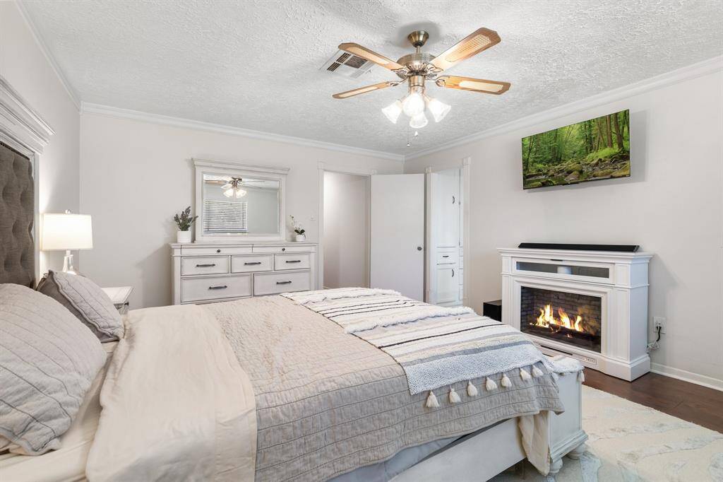 Primary bedroom with electric fireplace.