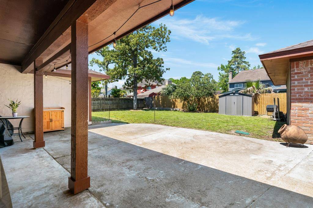 Large fenced backyard with storage shed.