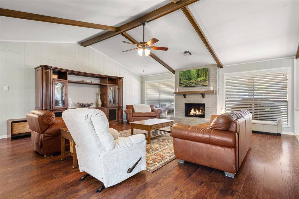 Wood beams on vaulted ceiling and beautiful flooring.