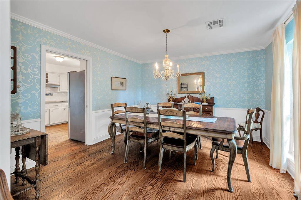 the The formal dining room connects the formal living room in a elbow to the kitchen.