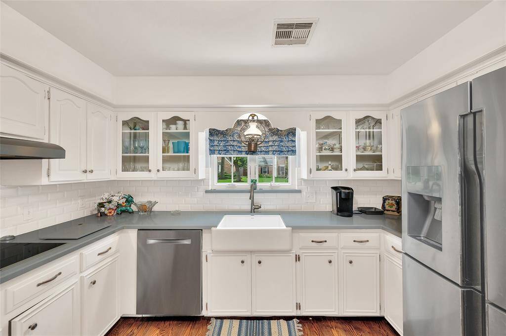 The window over the porcelain apron sink are the cook's view of life in the outside world.
