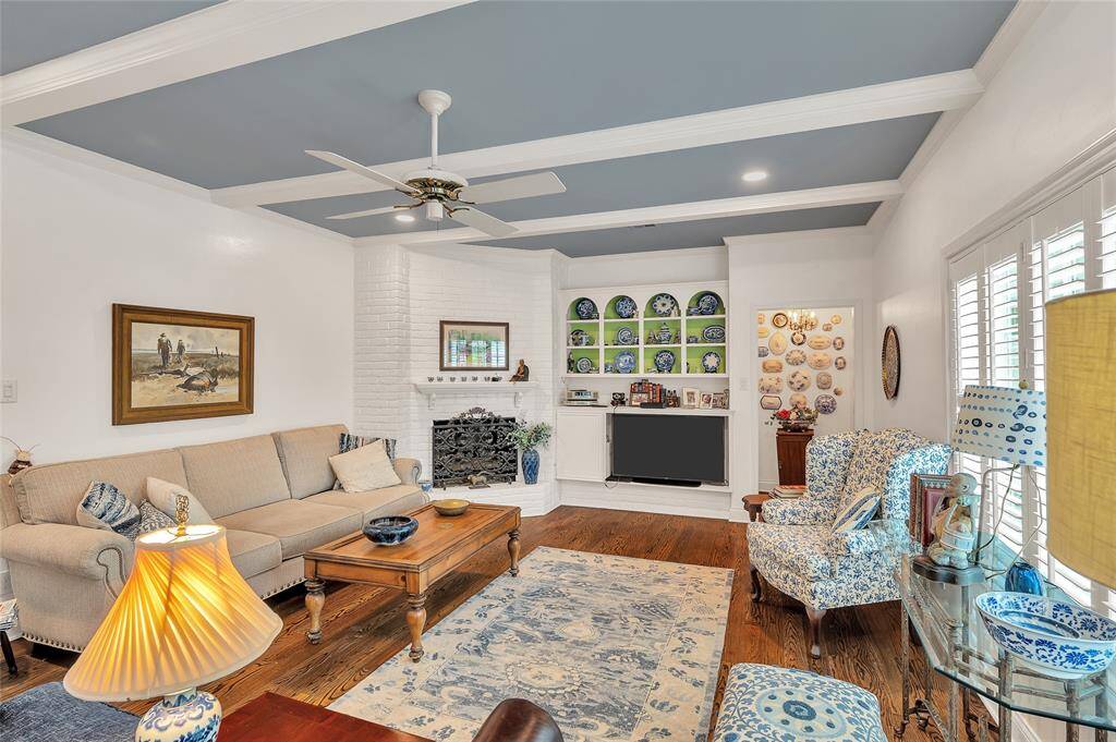 From the breakfast room, one enters the large den with a beamed ceiling, recessed lighting and a gaslog, corner fireplace.