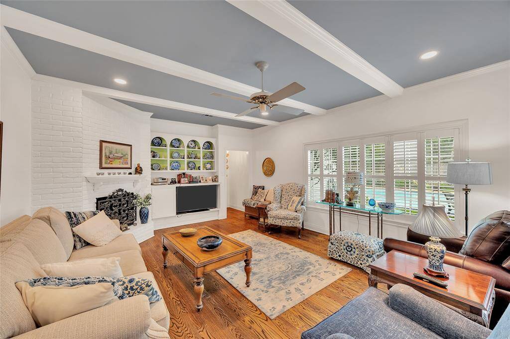 The spacious den has a wall of windows overlooking the patio and pool.