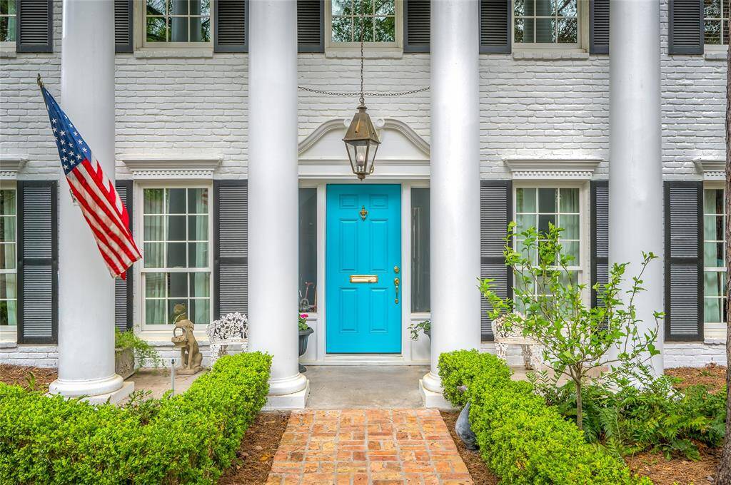 This classic home is nestled among mature live oak trees and was freshly painted classic white in February.