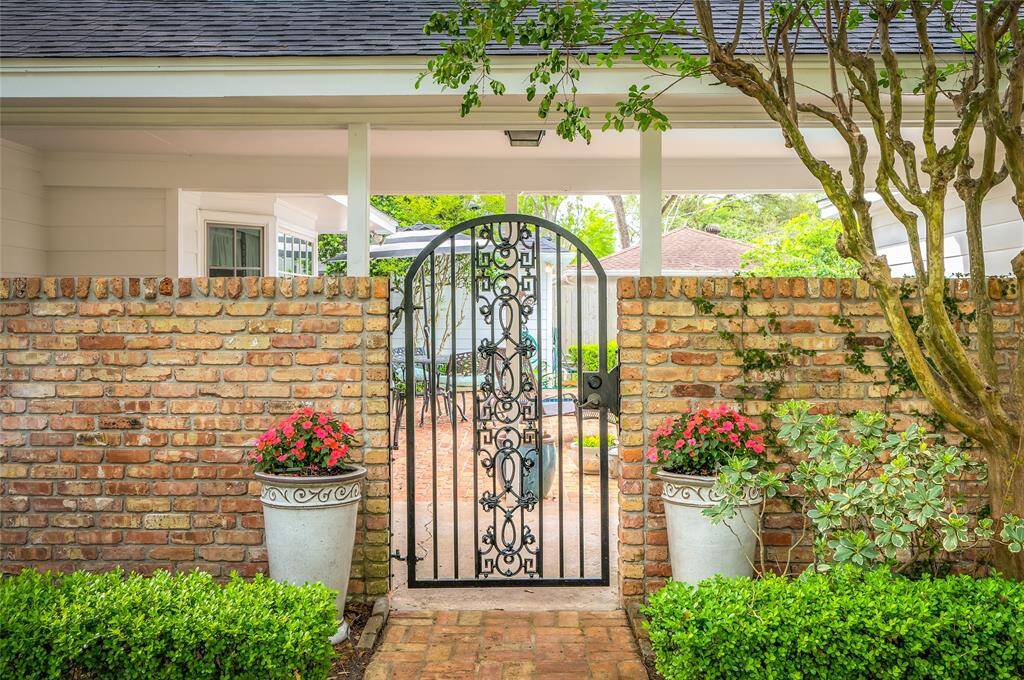 The wrought iron garden gate to breezeway and backyard resort.
