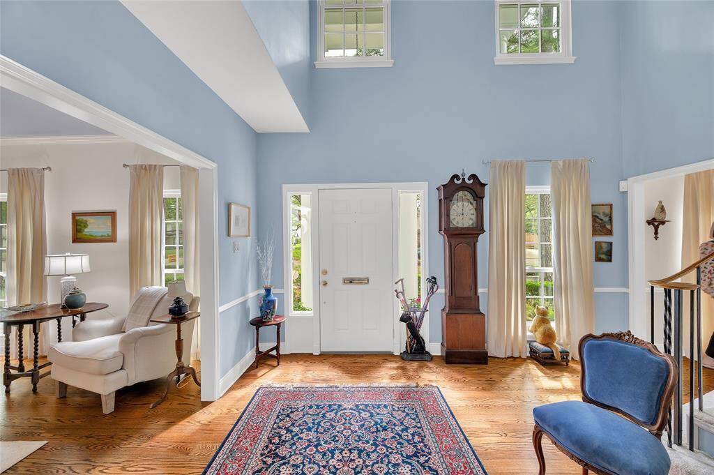 This two-story entry features high and low windows for natural light, creating a warm and especially welcoming feeling.