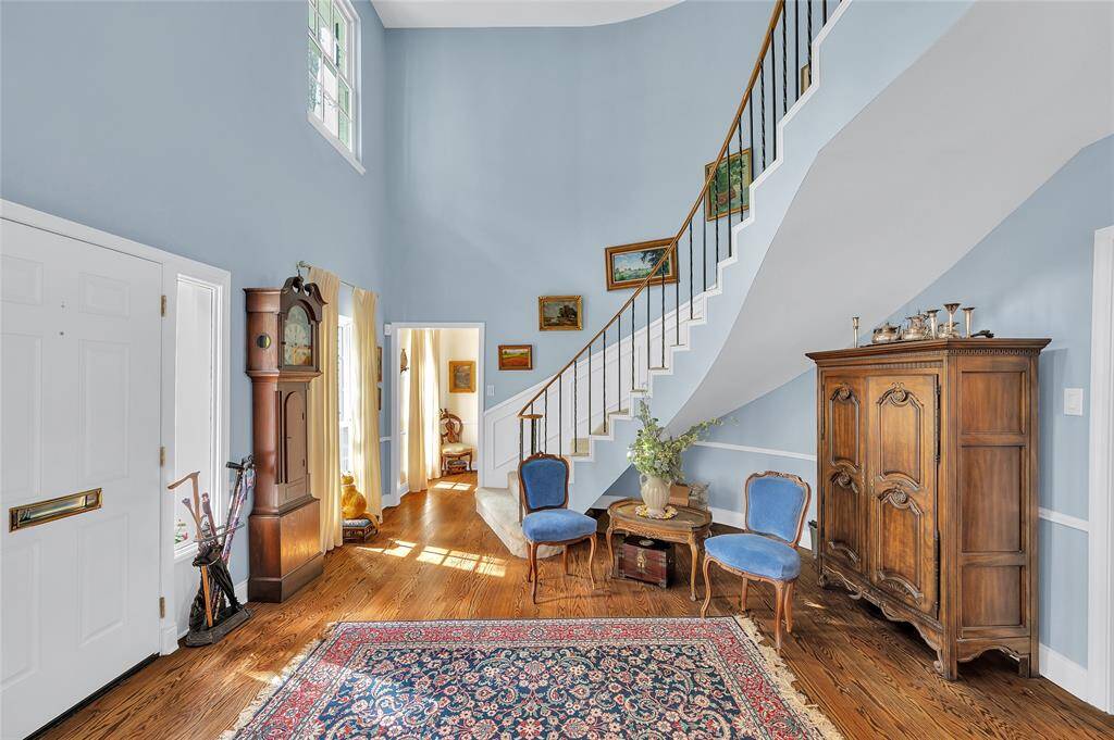 Such impressive charm!  Two-story entry with graceful spiral stairway