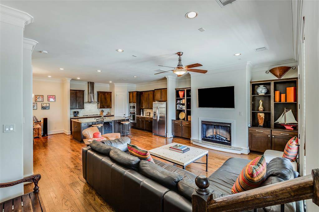 Open plan living room with gas fire & built ins & large kitchen with island, lots of cabinet space & walk in pantry