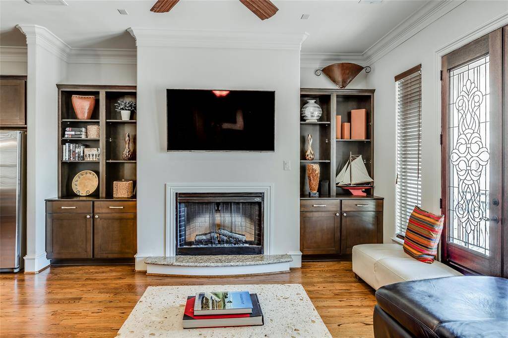 Beautiful Living Room with log fire, built-ins, hard wood floors, high ceiling & lead glass patio doors out to patio
